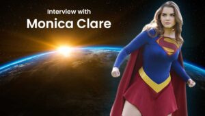 Image shows Monica Clare in Supergirl Cosplay in space with the Earth behind her and the sun just cresting over the earth.